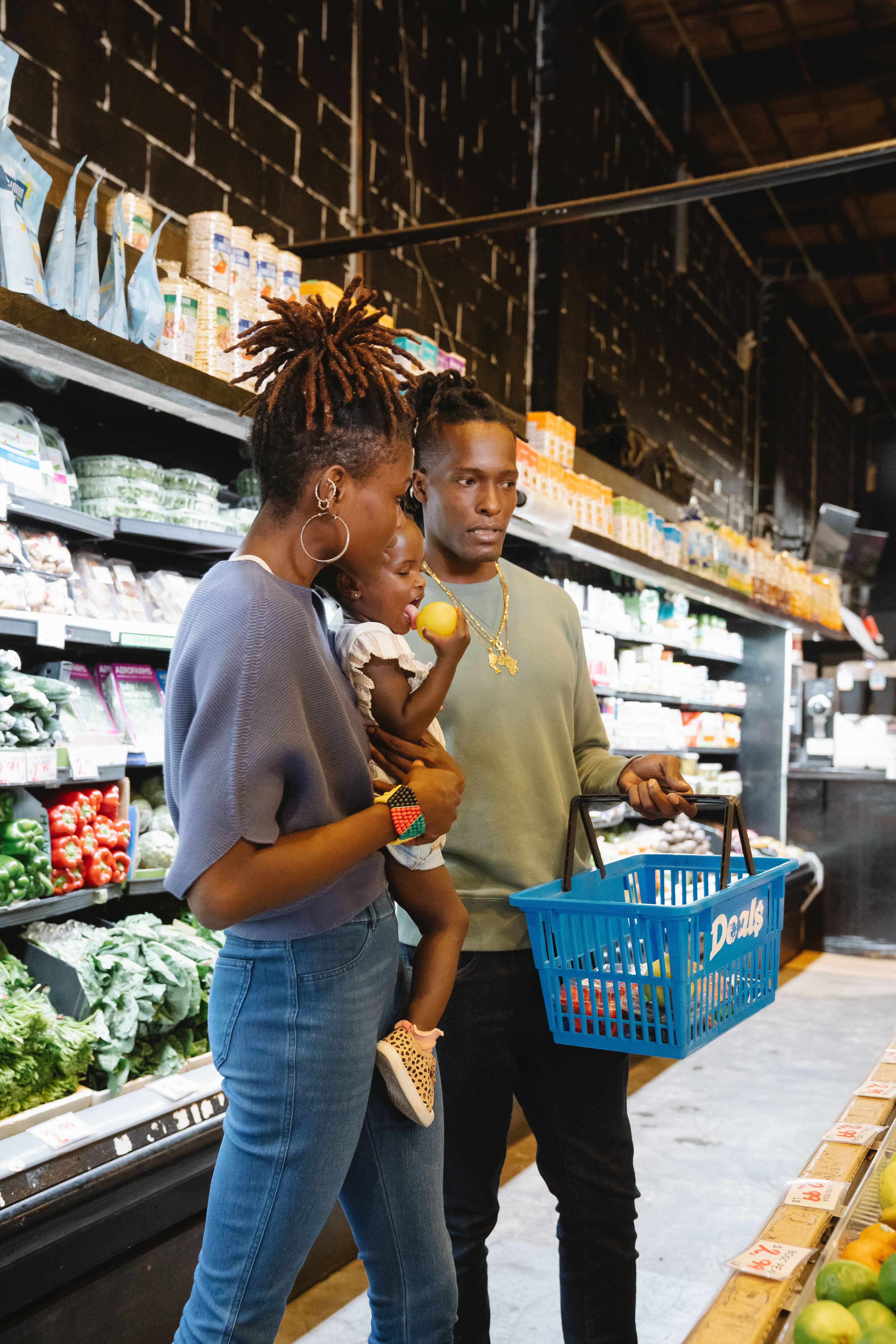 A family shopping together in a neighbourhood grocery store